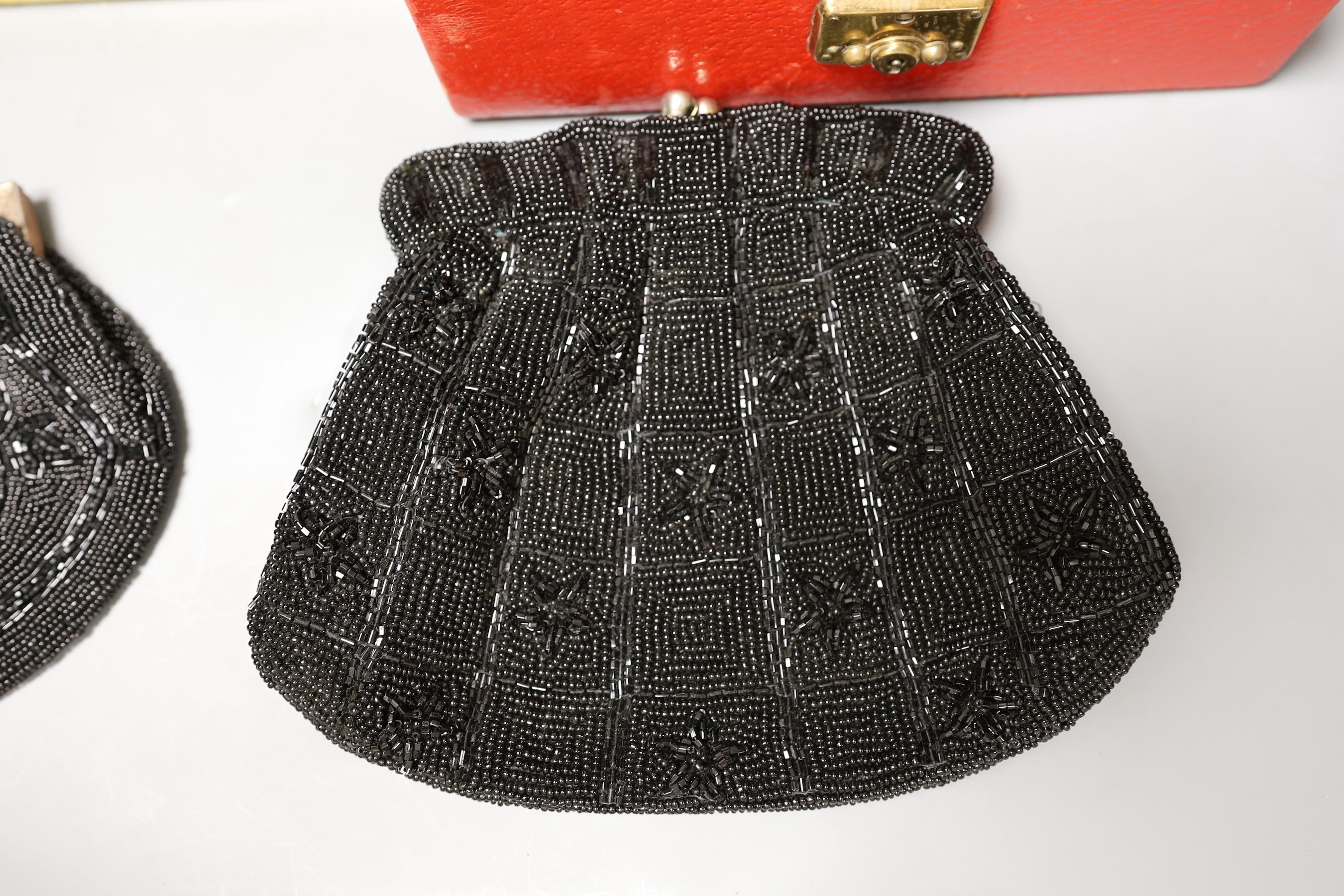 A 19th century cut steel, black velvet bag, a 1940’s-50’s diamanté handled clutch bag, 1930’s embroidered clutch bag, together with four later black beaded evening bags